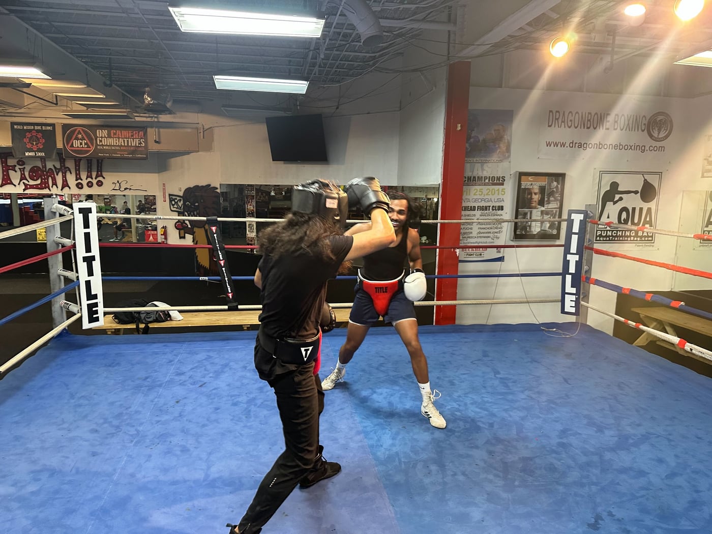 Erick training with a coach inside a boxing ring