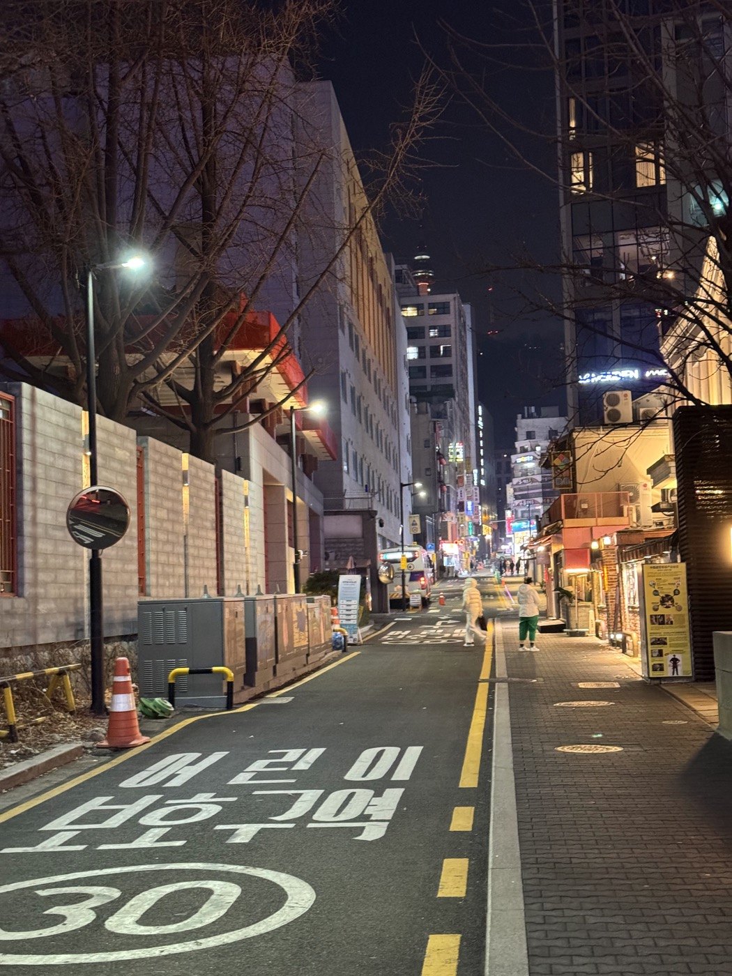 A quiet Korean street lit up at night