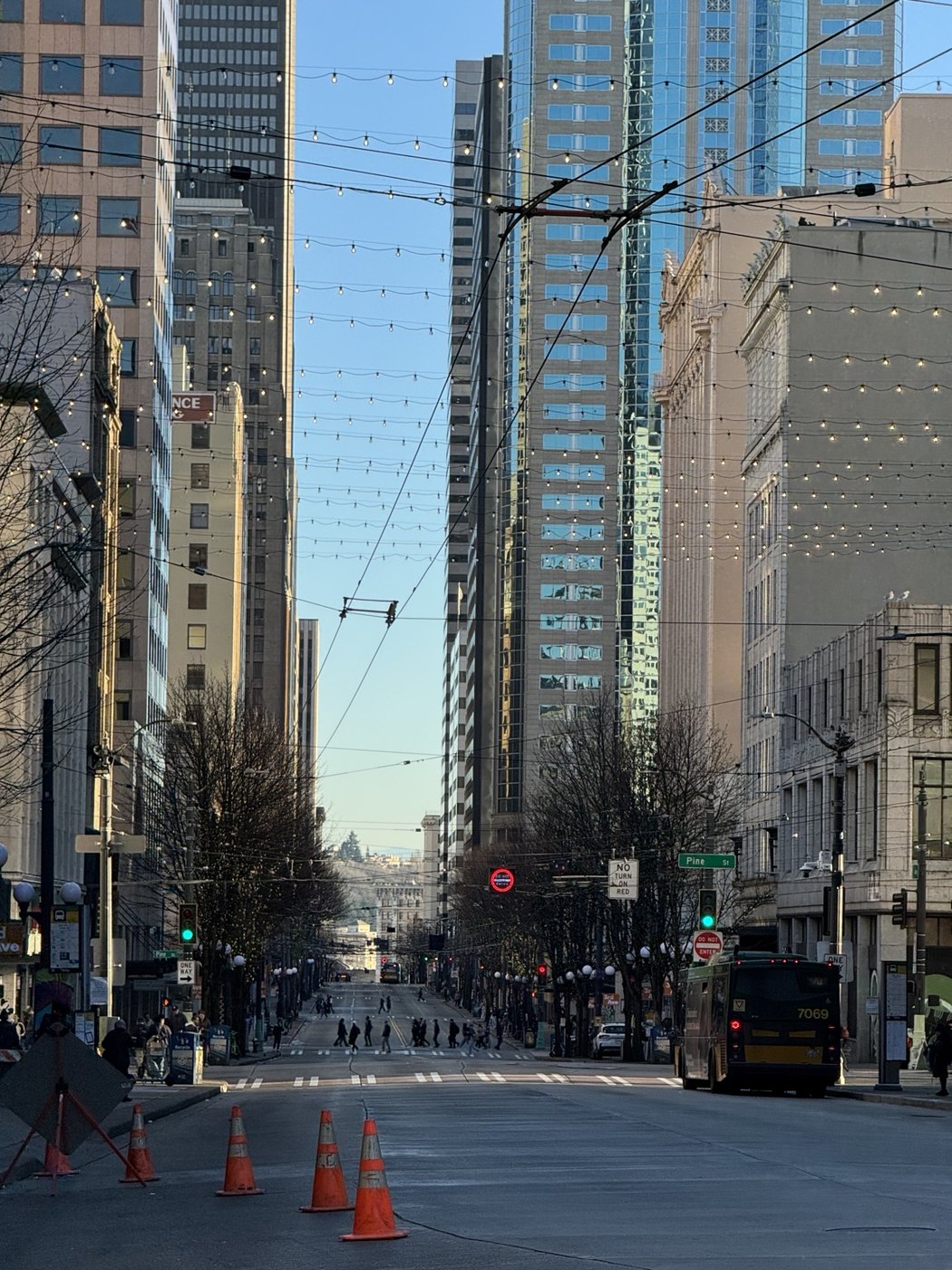 A downtown Seattle street beneath string lights