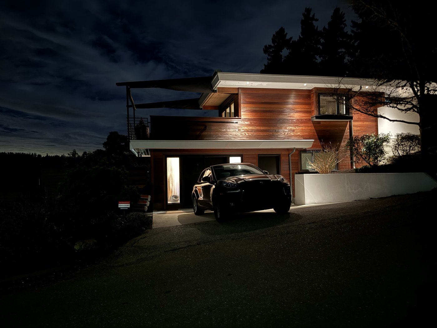 A modern Seattle home illuminated at night