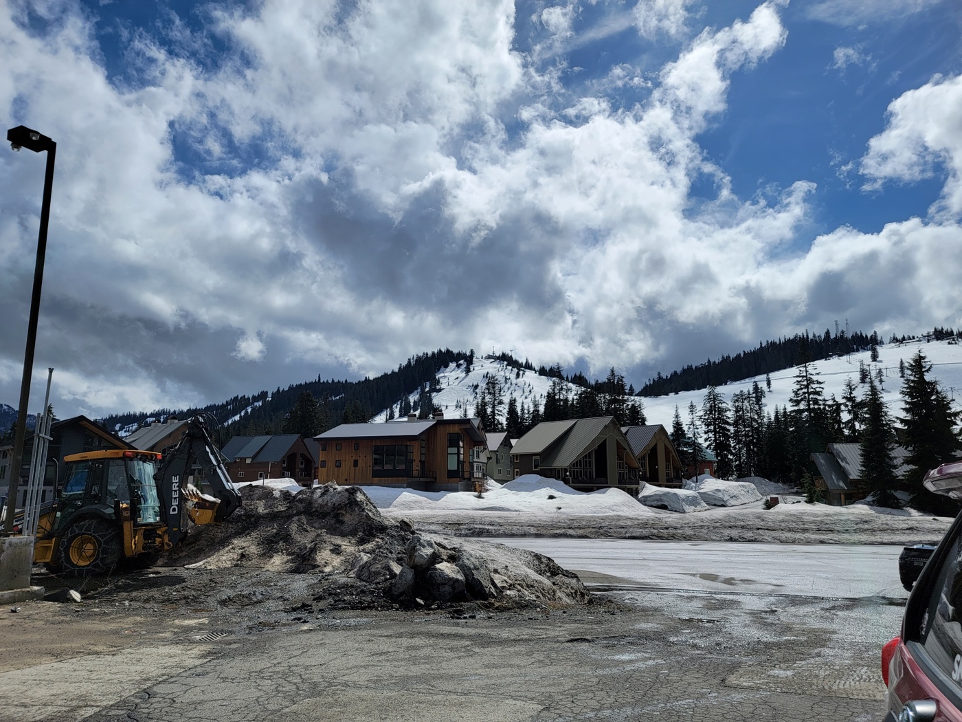Snowy cabins beneath dramatic clouds in the mountains